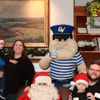 A family of four with Santa & Louie.